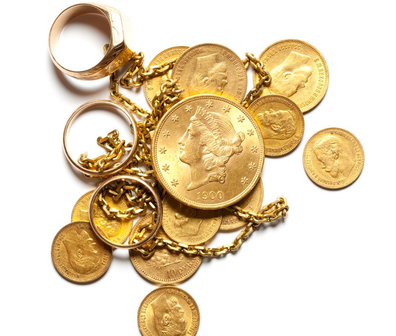 Gold rings, chains and old coins laid out for a Carrollton, Texas seller's appraisal