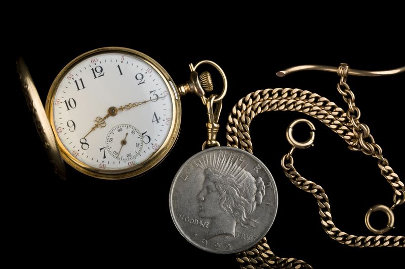 Antique pocket watch beside a Peace silver dollar from a Grapevine, Texas family