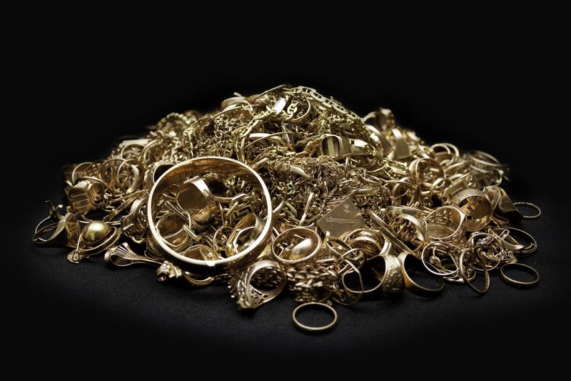 Gold rings and chains sorted by karat at a Dallas gold jewelry buyer
